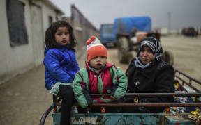 Refugee children arrive at the Turkish border crossing gate.