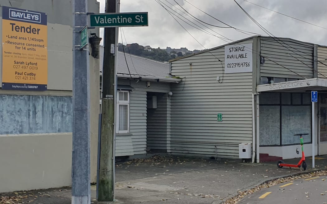 The burnt-out dairy in Alicetown on the right, and the property for sale on the left advertising 'Resource consented for 14 units'.