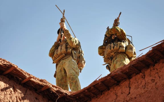 A handout photo released by Australian Department of Defence on October 21, 2009 shows Australian soldiers from the Special Operations Task Group using their rifle scopes to investigate the surrounding mountains during an operation in southern Afghanistan.