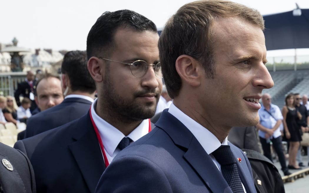 French President Emmanuel Macron (R) walking with bodyguard Alexandre Benalla.