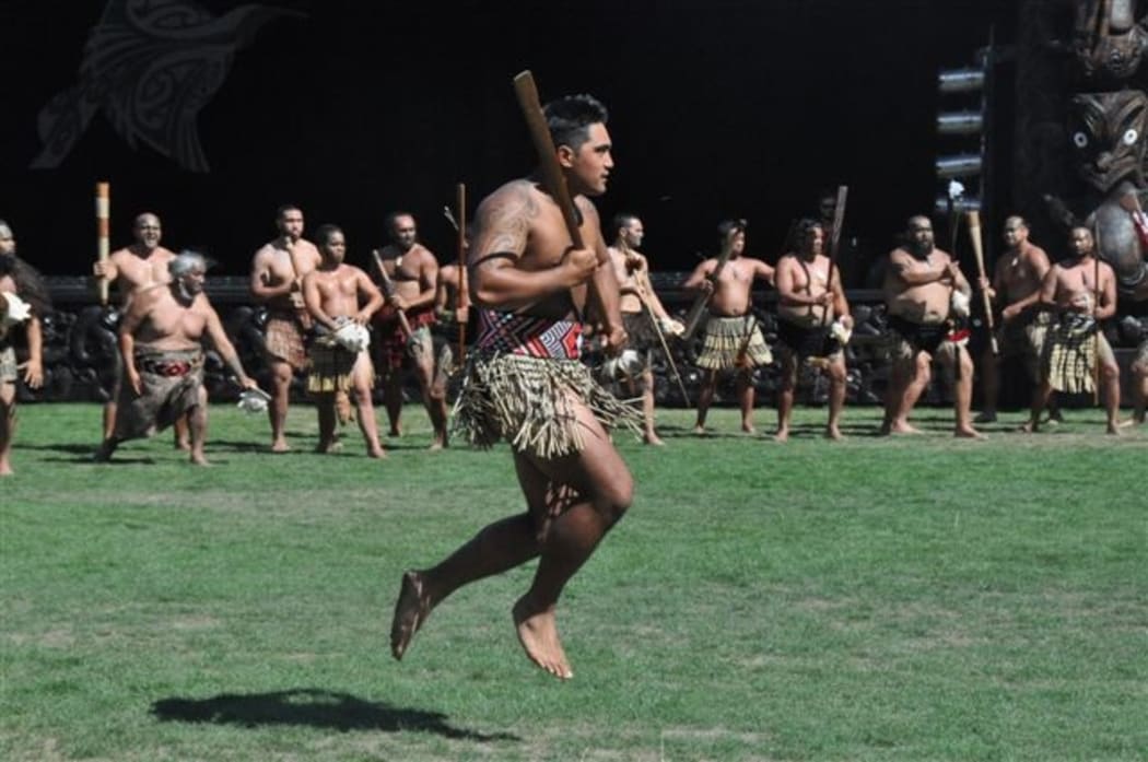 A Te Arawa warrior gives a wero ( challenge) at the welcoming ceremony.