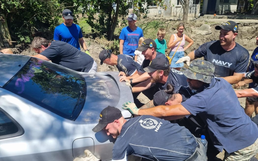 Houses on Joll Road in Havelock North were inundated with contaminated mud during Cyclone Gabrielle, but the community and Navy pitched in to help clean up the street and homes.