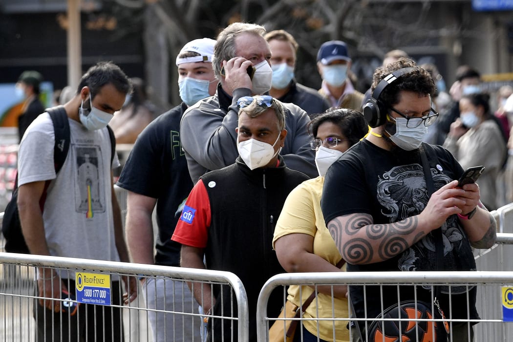 People wait in a queue for their Covid-19 coronavirus vaccination in Sydney.