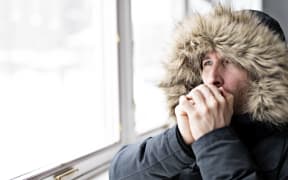 A Man With Warm Clothing Feeling The Cold Inside House