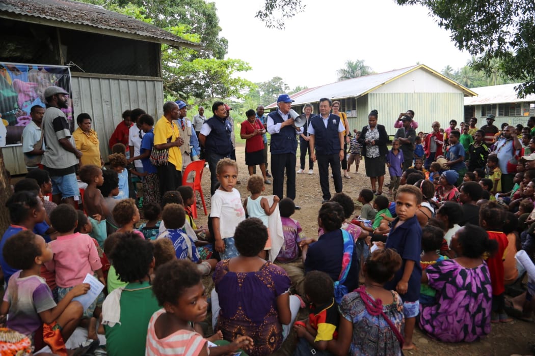 The WHO in PNG speaking to the community in Lae