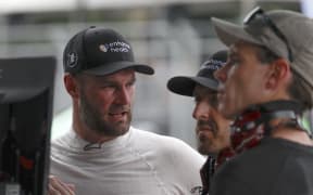 Shane Van Gisbergen works with crew in the garage area during qualifying for the NASCAR Cup Series Grant Park 220 at the Chicago Street Course.