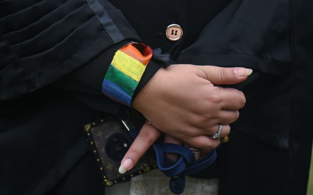 A lawyer can be seen wearing a rainbow flag wristband at the courtyard of the Supreme Court of India, during the judgement on same-sex marriage by Supreme Court in New Delhi, India on October 17, 2023. India's top court said on Tuesday that it cannot legalise same-sex marriages. (Photo by Kabir Jhangiani/NurPhoto) (Photo by Kabir Jhangiani / NurPhoto / NurPhoto via AFP)