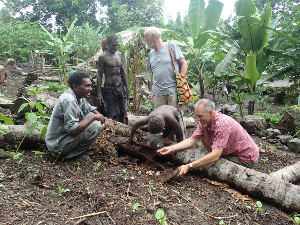 Scientists Sean Marshall and Bob Macfarlane expaining Coconut Rhinoceros Beetle invasion to Solomon Islands villagers