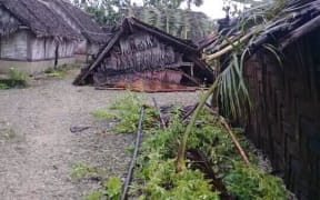 A damaged house, fallen trees and damaged gardens on Uripiv, a low-lying island close to Malekula.