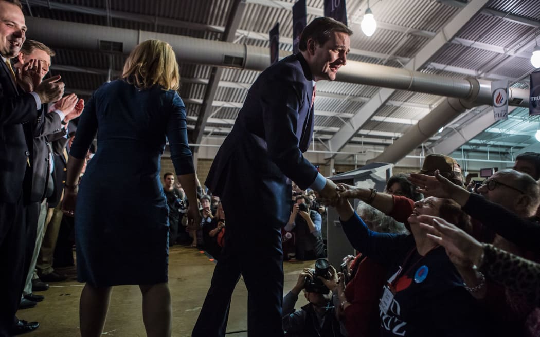 Republican presidential candidate Senator Ted Cruz greets audience members before speaking at a caucus night rally