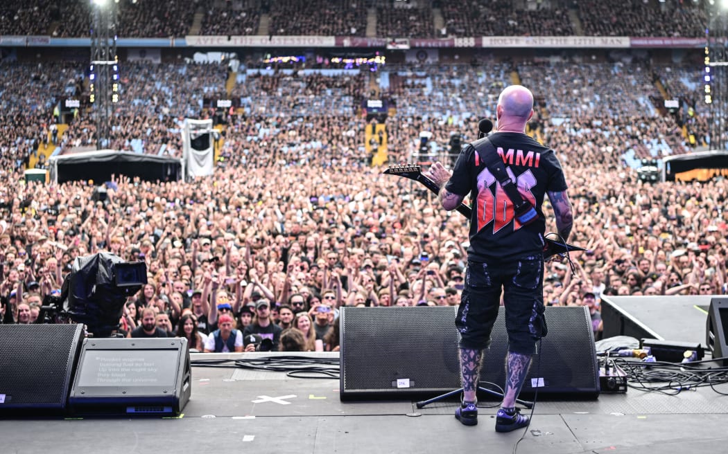 Member of US rock band Anthrax, Scott Ian plays to the crowd as a support act, during British rock band Black Sabbath's "Back to The Beginning" concert, Ozzy Osbourne's final ever gig as Black Sabbath's frontman at Villa Park in Birmingham, central England on July 5, 2025. Osbourne, who revealed in 2020 that he has Parkinson's disease, will join Tony Iommi, Geezer Butler and Bill Ward for the all-day "Back To The Beginning" show in Birmingham, central England, where the heavy metal giants formed in 1968. (Photo by Andy Buchanan / AFP)