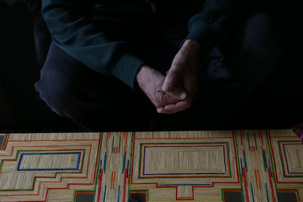 His hands and a table he decorated with matchsticks.