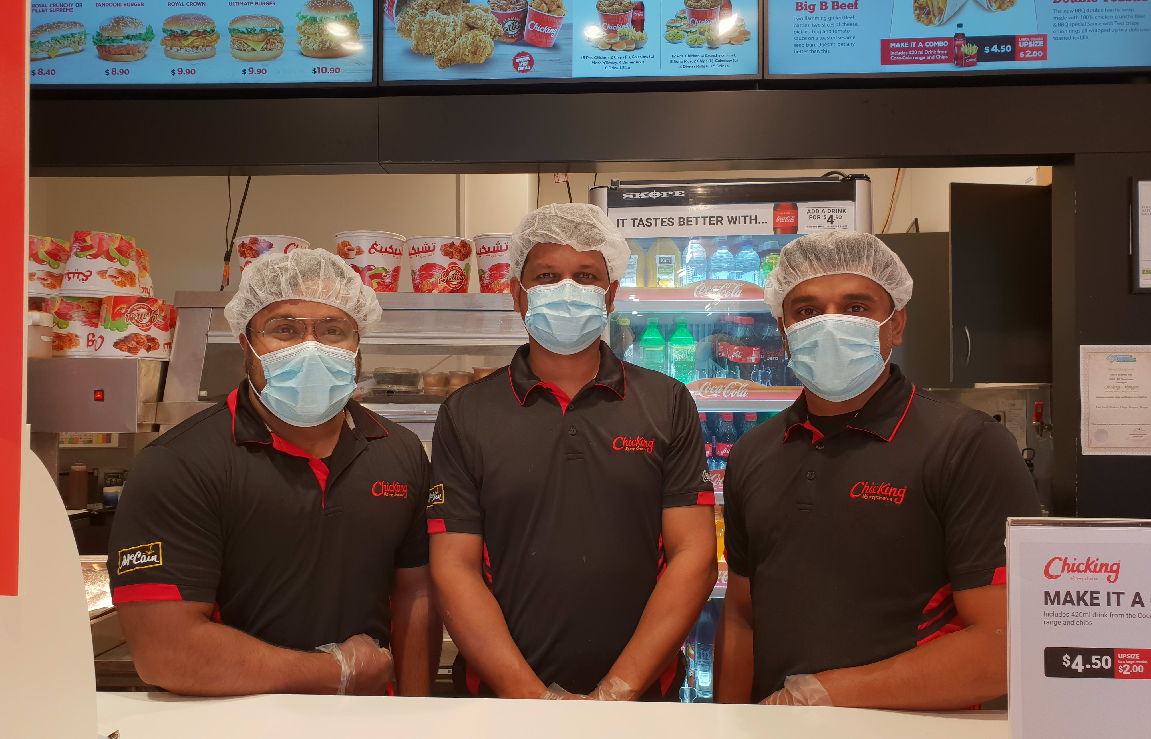 Staff members Alan Stani, Noel Pinheiro, Manu Maret at Chicking Māngere.