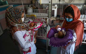 Nurses feed newborn babies whose mothers were killed in the attack on a maternity ward in Kabul on 12 May.