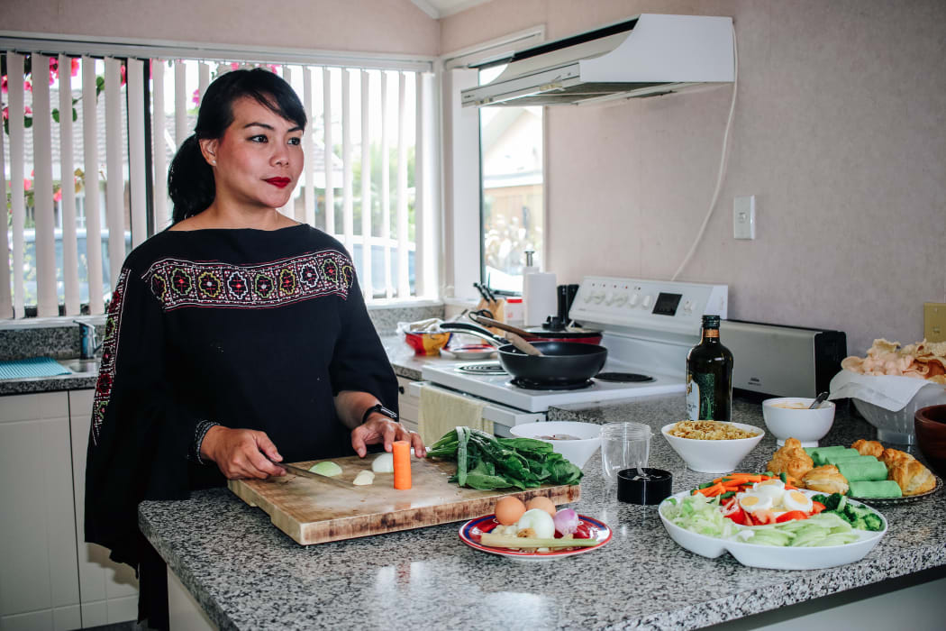Dewi Astutipuji as she prepares Indonesian food as lunch for a big gathering.