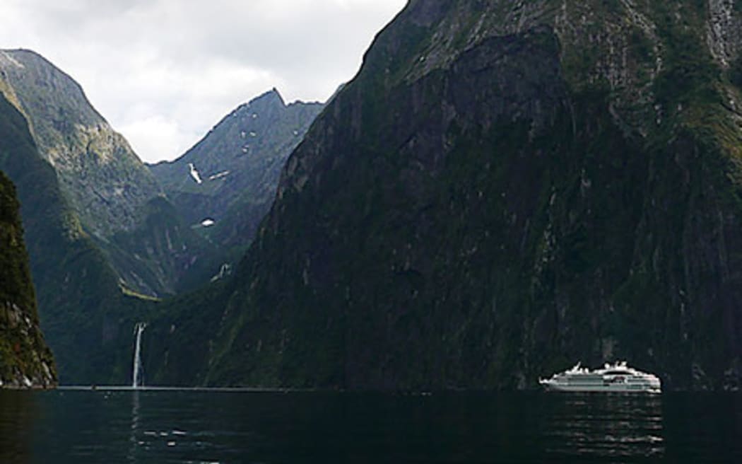 Le Soléal dwarfed by mountains of Piopiotahi Milford Sound