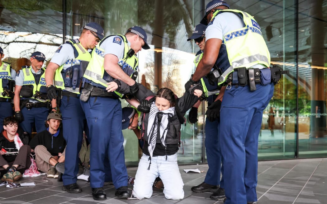 Several protesters have been carried away by police outside the national aerospace summit in Christchurch.