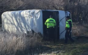 The overturned bus at the scene of the crash.