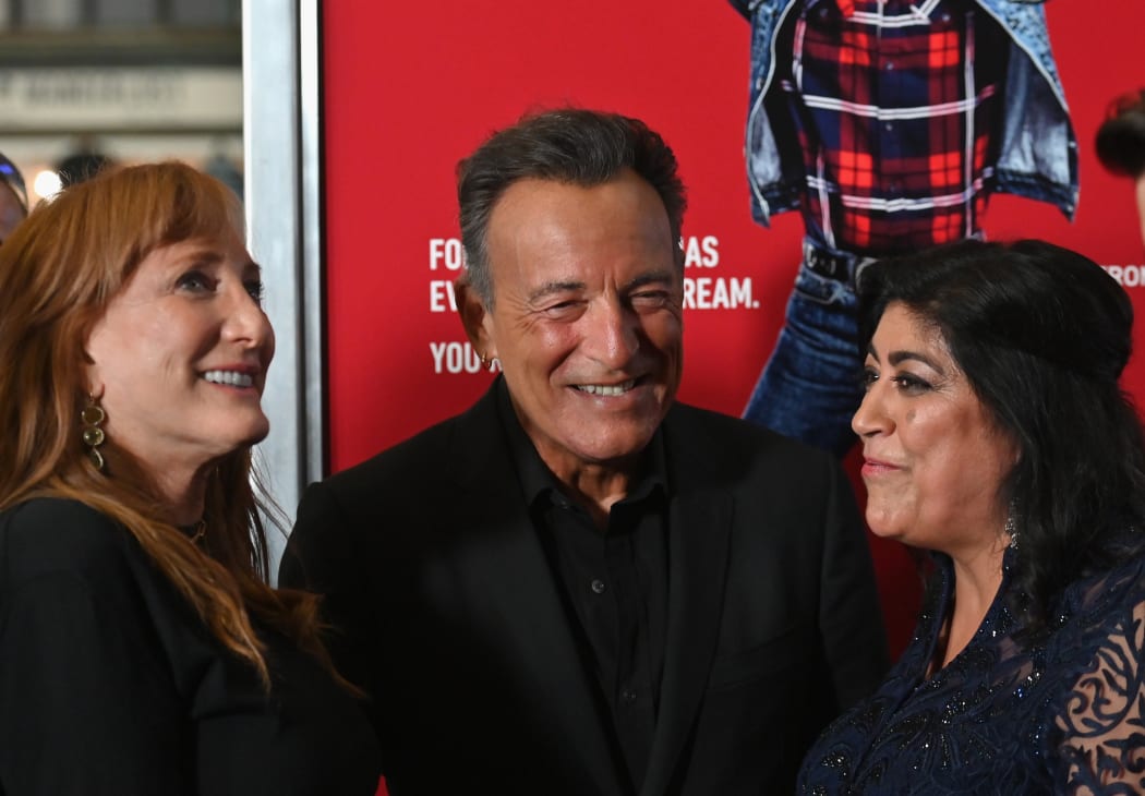 Guitarist Patti Scialfa with her husband, Bruce Springsteen, and director Gurinder Chadha chat as they attend the premiere of Blinded by the Light on 7 August, 2019 in Asbury Park, New Jersey.