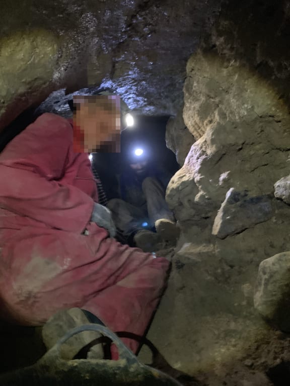 Men in the 'secret' cave - Waikaretu Valley