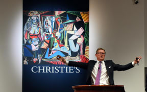 Jussi Pylkkanen, president of Christie's, takes bids in New York art work, "Les femmes d'Alger" by Pablo Picasso.