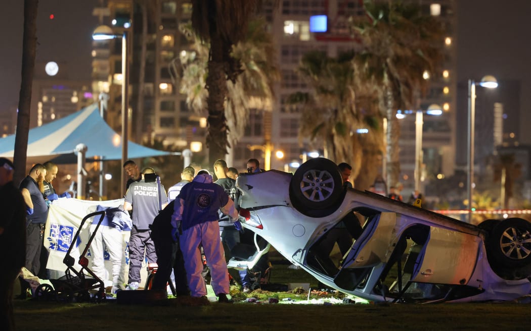 Israeli police inspect the car used in an attack in Tel Aviv on April 7, 2023.
