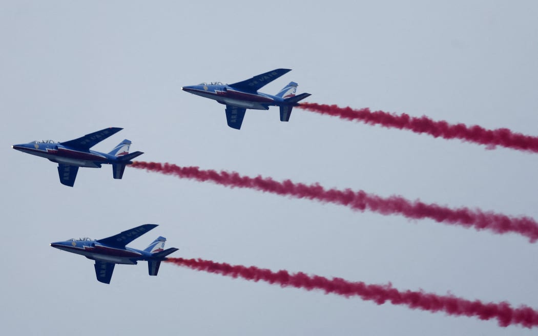 Paris 2024 Olympics - Opening Ceremony - Paris, France - July 26, 2024. Aircrafts of the Patrouille de France are seen flying over Paris during the opening ceremony. (Photo by Clodagh Kilcoyne / POOL / AFP)