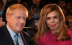 File photo taken on October 02, 2019 Britain's Prime Minister Boris Johnson leaves with his partner Carrie Symonds.