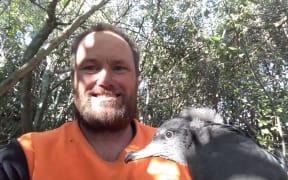 Mike Bell with a flesh footed shearwater chick.