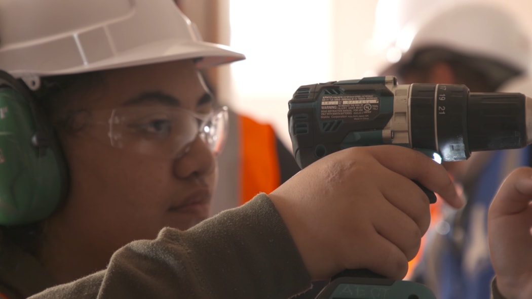Women working in trades, construction.