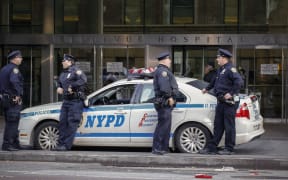 Police officers in front of Bellevue Hospital where Dr Craig Spencer, who was diagnosed with Ebola, remains in quarantine.