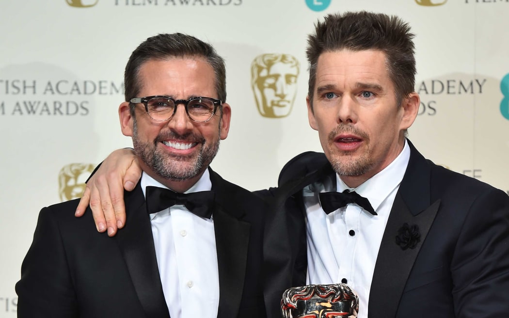 Actor Ethan Hawke, right, collects the Boyhood award on behalf of US director Richard Linklater, and poses with presenter Steve Carell.