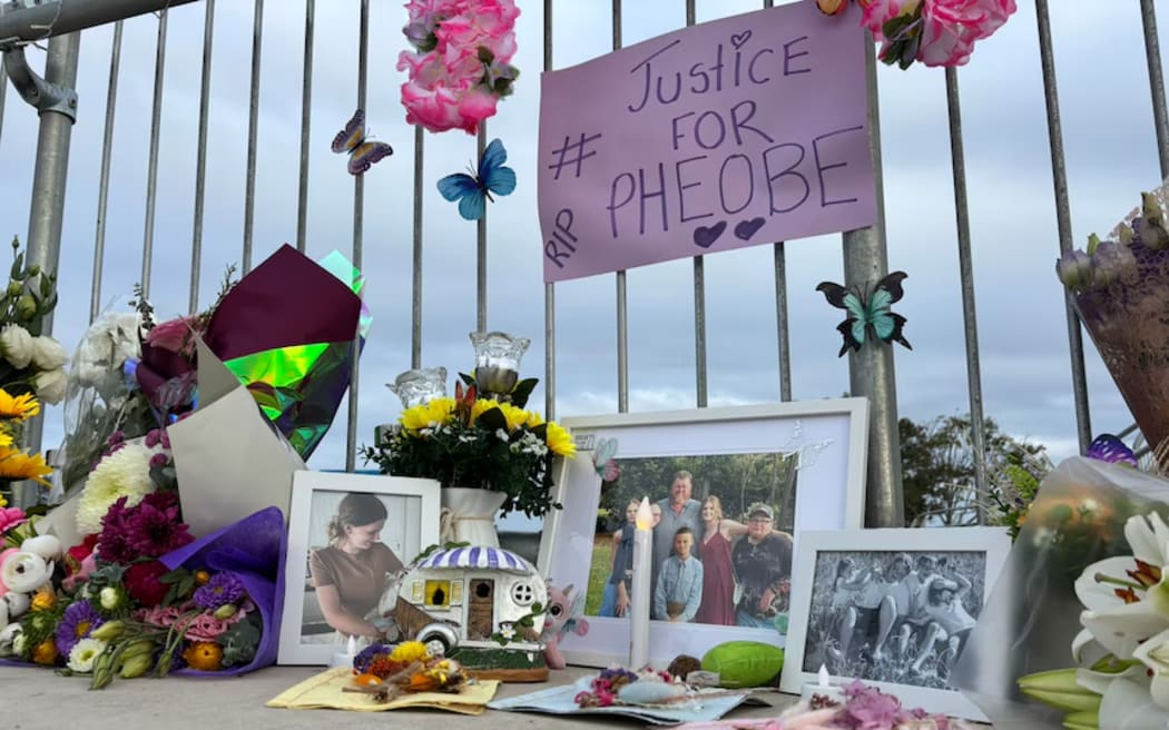 Flowers, photographs and notes at the end of Airport Drive in Bundaberg, laid in memory of missing teenager Pheobe Bishop.
