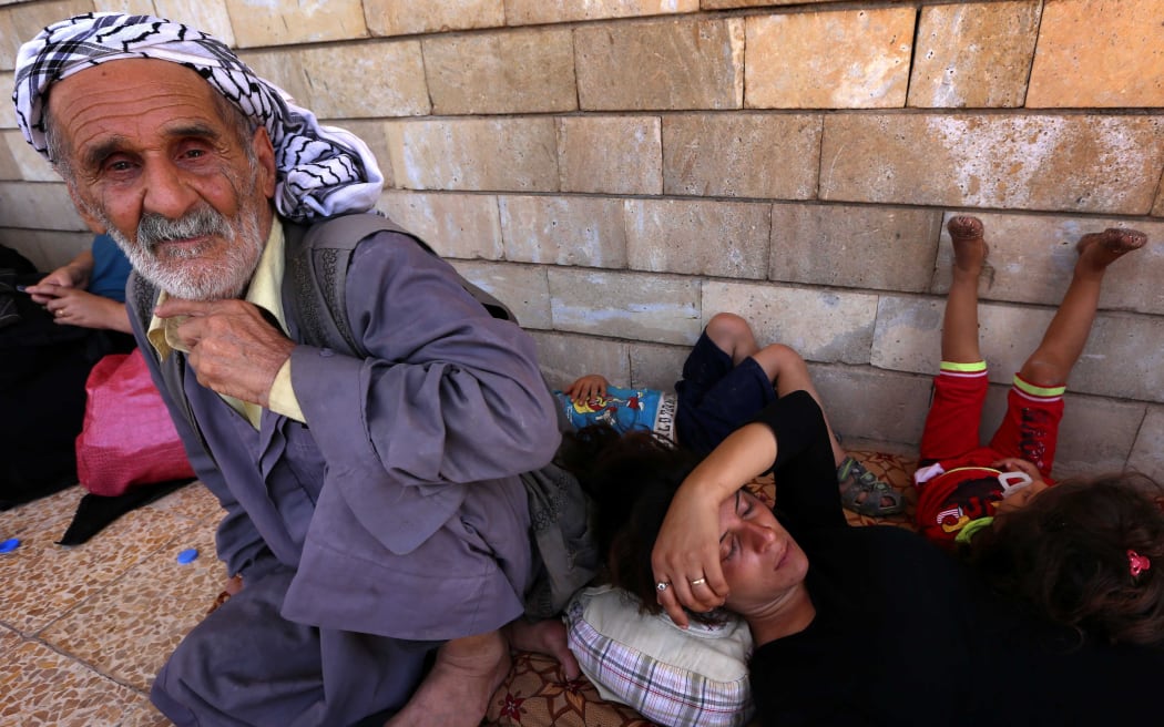 Iraqi Christians who fled violence in Nineveh, rest at the Saint-Joseph church in the Kurdish city of Arbil.