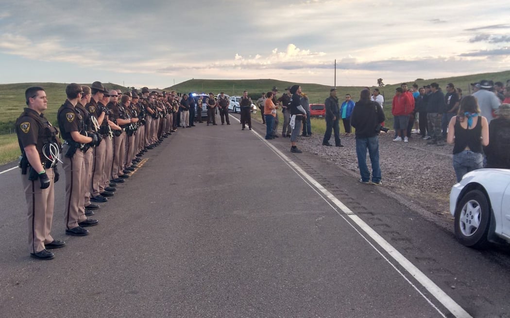 Police officers gather before moving in on protesters.