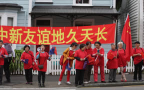 People wait to welcome Mr Li into the country.