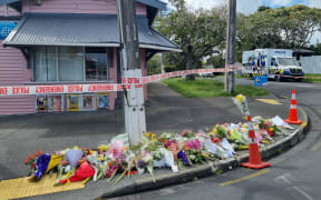 Flowers are seen outside Rose Cottage Superette in Sandringham, Auckland, after the fatal stabbing of a dairy worker on Wednesday, 23 November, 2022.
