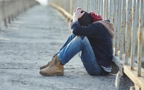 young homeless boy sleeping on the bridge, poverty, city, street