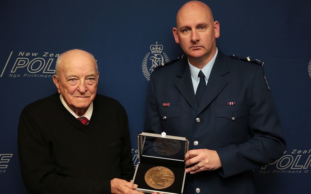 Graham McColl and senior constable Karl Williams with the WWI memorial plaque.