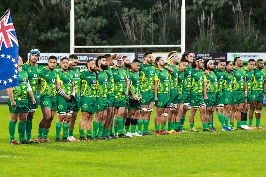 The Cook Islands rugby team stand for the national anthem.