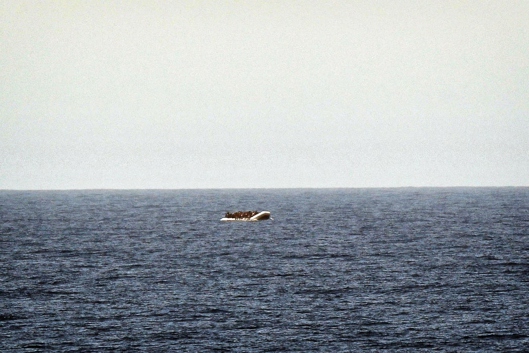 A rubber boat with migrants is seen off the Libya coast in May.