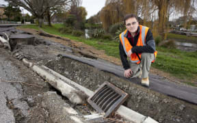 Misko Cubrinovski, from the University of Canterbury's School of Engineering, studies liquefaction and lateral spreading on Oxford Terrace, after the 2011 Christchurch earthquake.