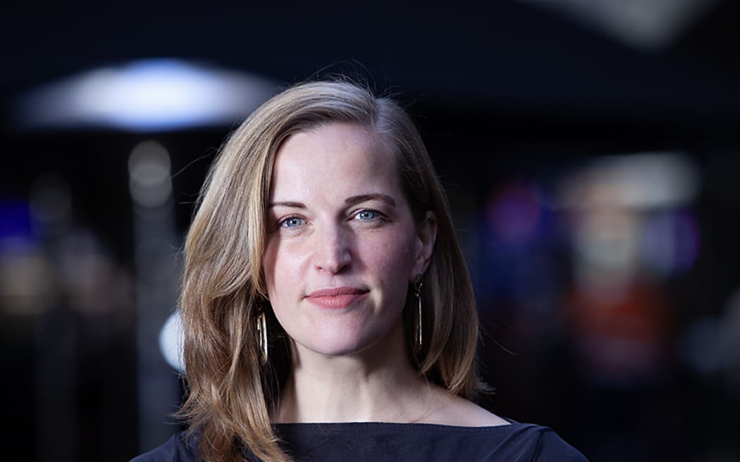 This is a head and shoulders photo of Clare. She is stood on the street, but the background is very soft focus.