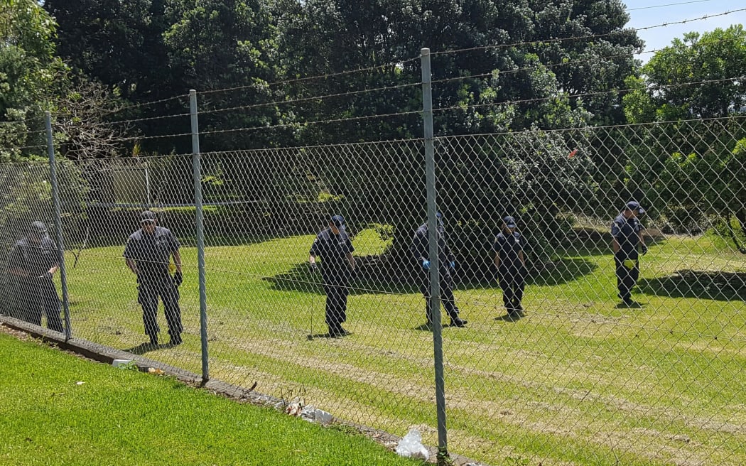 Police search the Mangere Bridge park where the baby's body was found.