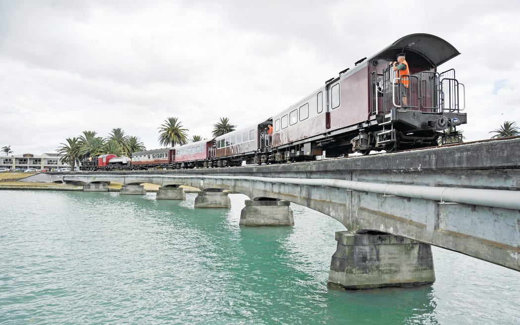 Credit: Liam Clayton/Gisborne Herald. Caption: The Wa165 crossing the Tūranganui River railway bridge in 2017. The bridge was recently found to be unsafe for the train, without “significant remedial work” being undertaken.