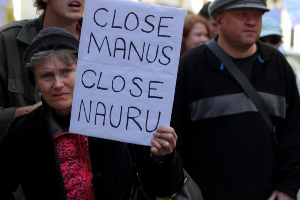 Street marcher with sign calling for closure of Nauru and Manus island detention center during World Refugee Rally June 20, 2015 in Brisbane, Australia.