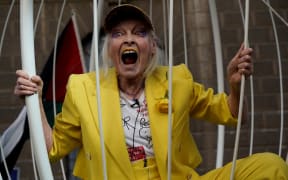 British designer Vivienne Westwood gesturing from inside a giant bird-cage, suspended in front Of the Old Bailey in central London, in protest of the extradition trial of Wikileaks founder Julian Assange, on 21 July, 2020.