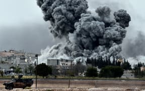 Smoke rises after a strike on Kobane by the Kurds, as seen from the Turkish-Syrian border.
