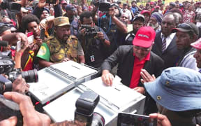 Papua New Guinea prime minister Peter O'Neill casts his vote in the 2017 election in his electorate of Ialibu-Pangia.