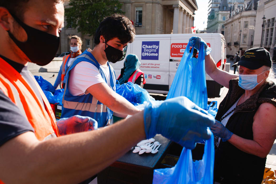 Volunteers from the Charity Begins At Home non-profit group hand out food parcels at a 'mobile food bank' in Trafalgar Square in London.